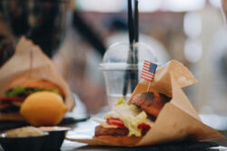 A close-up of a cheeseburger on a table.
