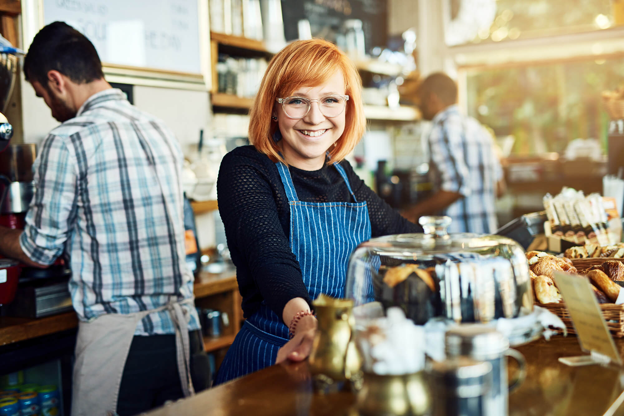 My cafe is the busiest on the block, photo of woman at counter, for the franchise advantages and disadvantages blog